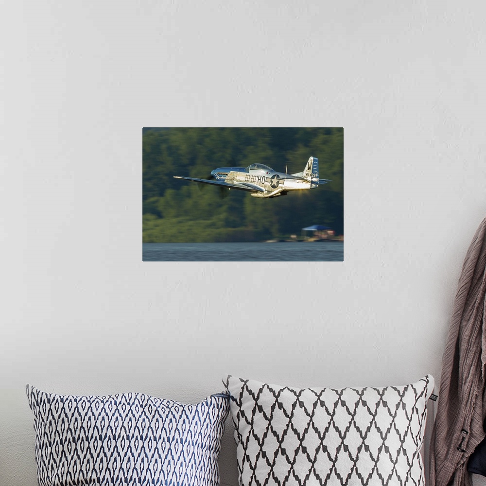 A bohemian room featuring A P-51 Mustang flies along the Mississippi at Dubuque, Iowa.
