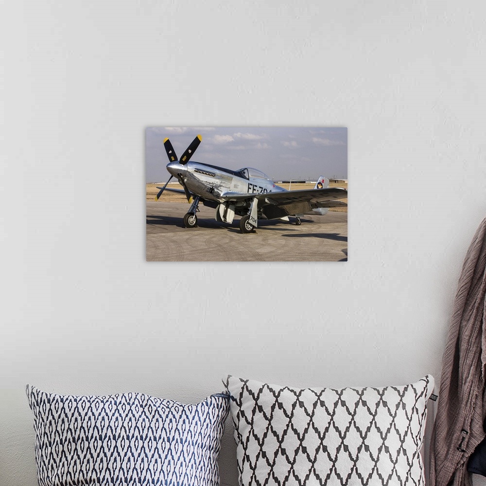A bohemian room featuring A P-51 Mustang parked on the ramp at Arlington, Texas.