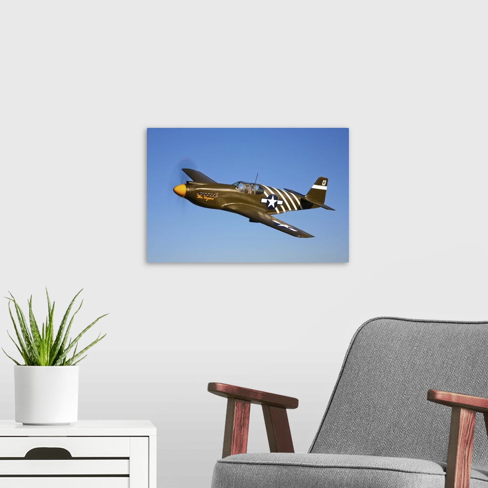 A modern room featuring A P-51A Mustang in flight near Chino, California.