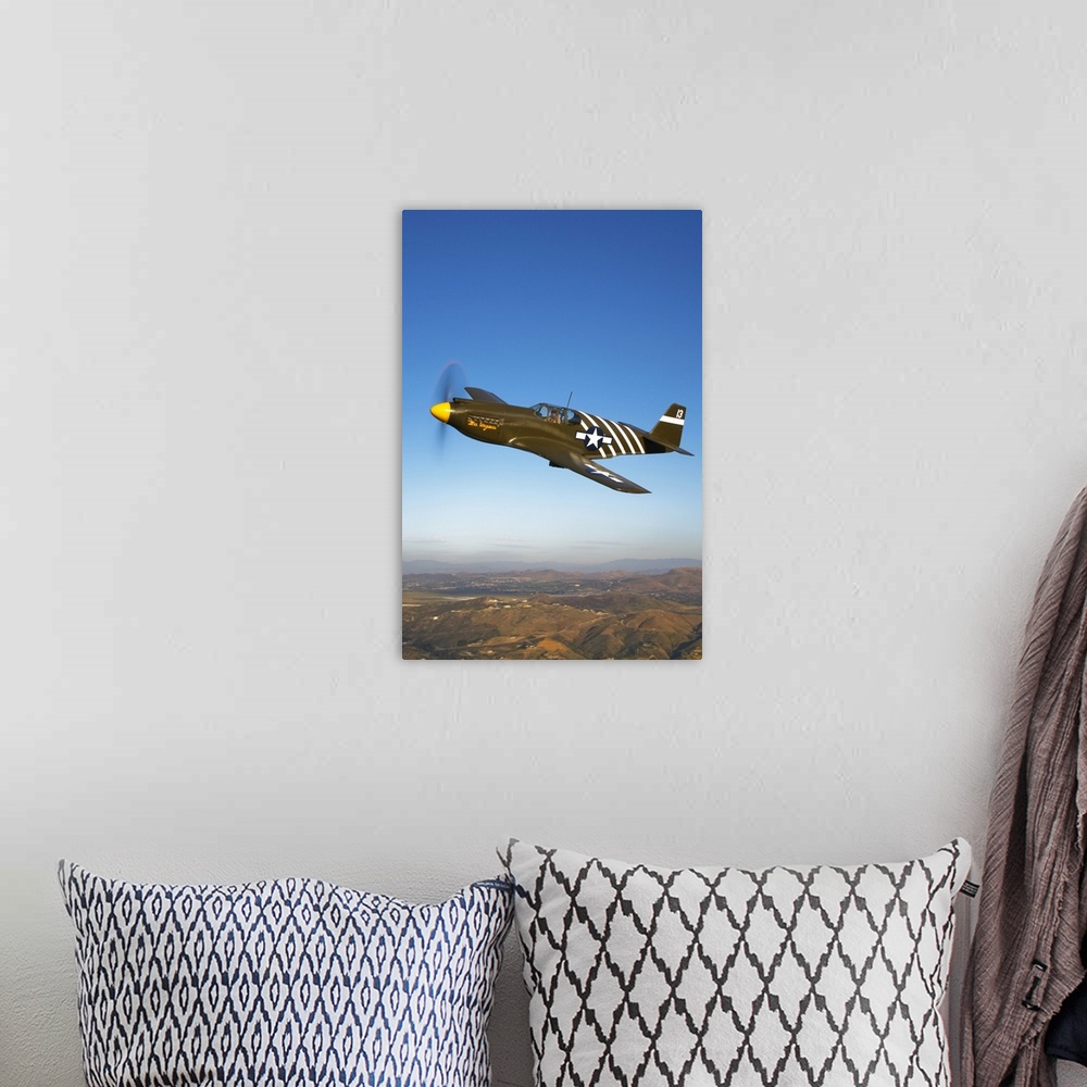 A bohemian room featuring A P-51A Mustang in flight near Chino, California.
