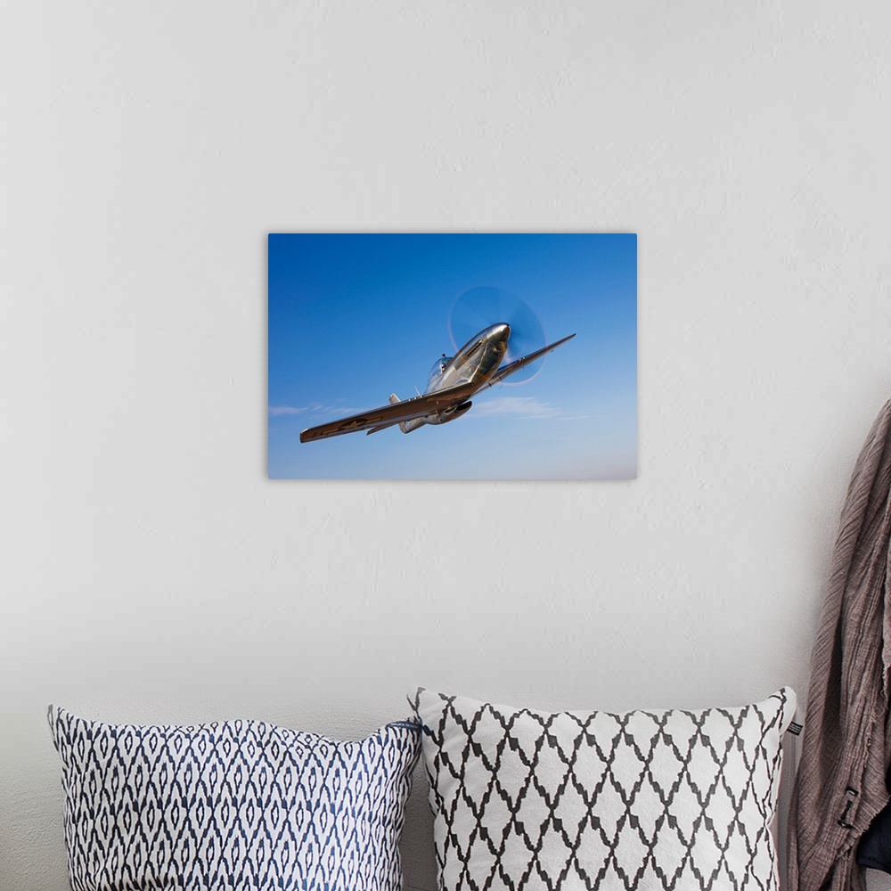 A bohemian room featuring Landscape photograph on a large canvas of a P-51D Mustang in flight, against a bright blue sky ne...