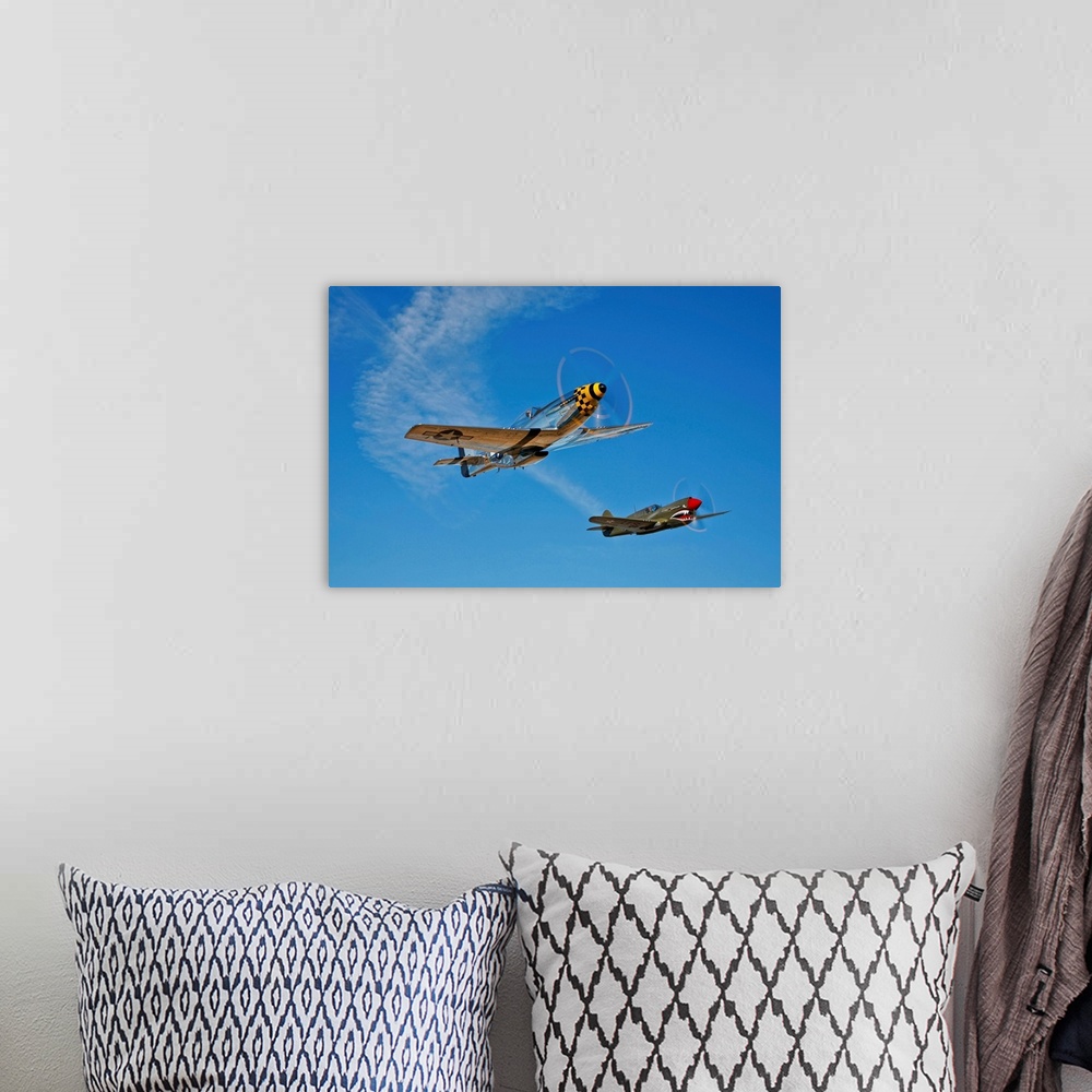 A bohemian room featuring A North American P-51D Mustang Kimberly Kaye and a Curtiss P-40E Warhawk in flight near Chino, Ca...