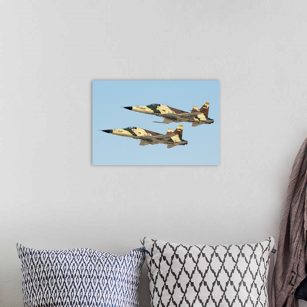 A bohemian room featuring A pair of Islamic Republic of Iran Air Force HESA Saegheh I aircraft in flight.