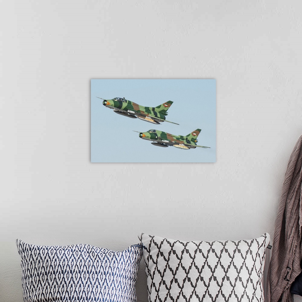 A bohemian room featuring A pair of Islamic Revolutionary Guard Corps Sukhoi Su-22 fighter jets.