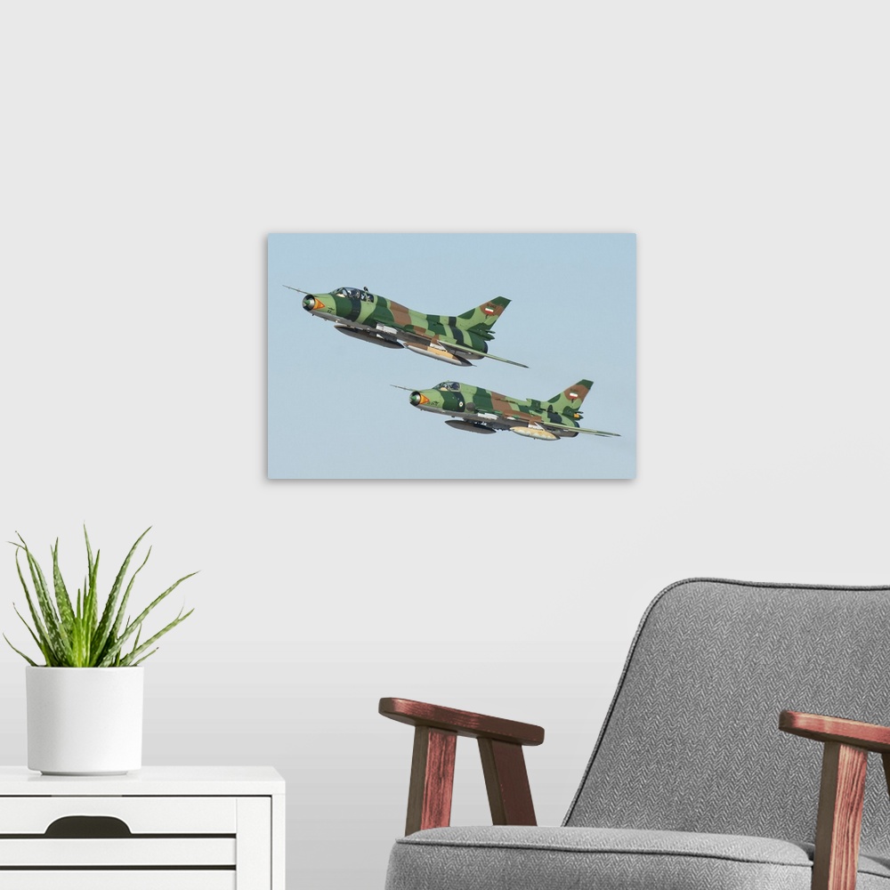 A modern room featuring A pair of Islamic Revolutionary Guard Corps Sukhoi Su-22 fighter jets.