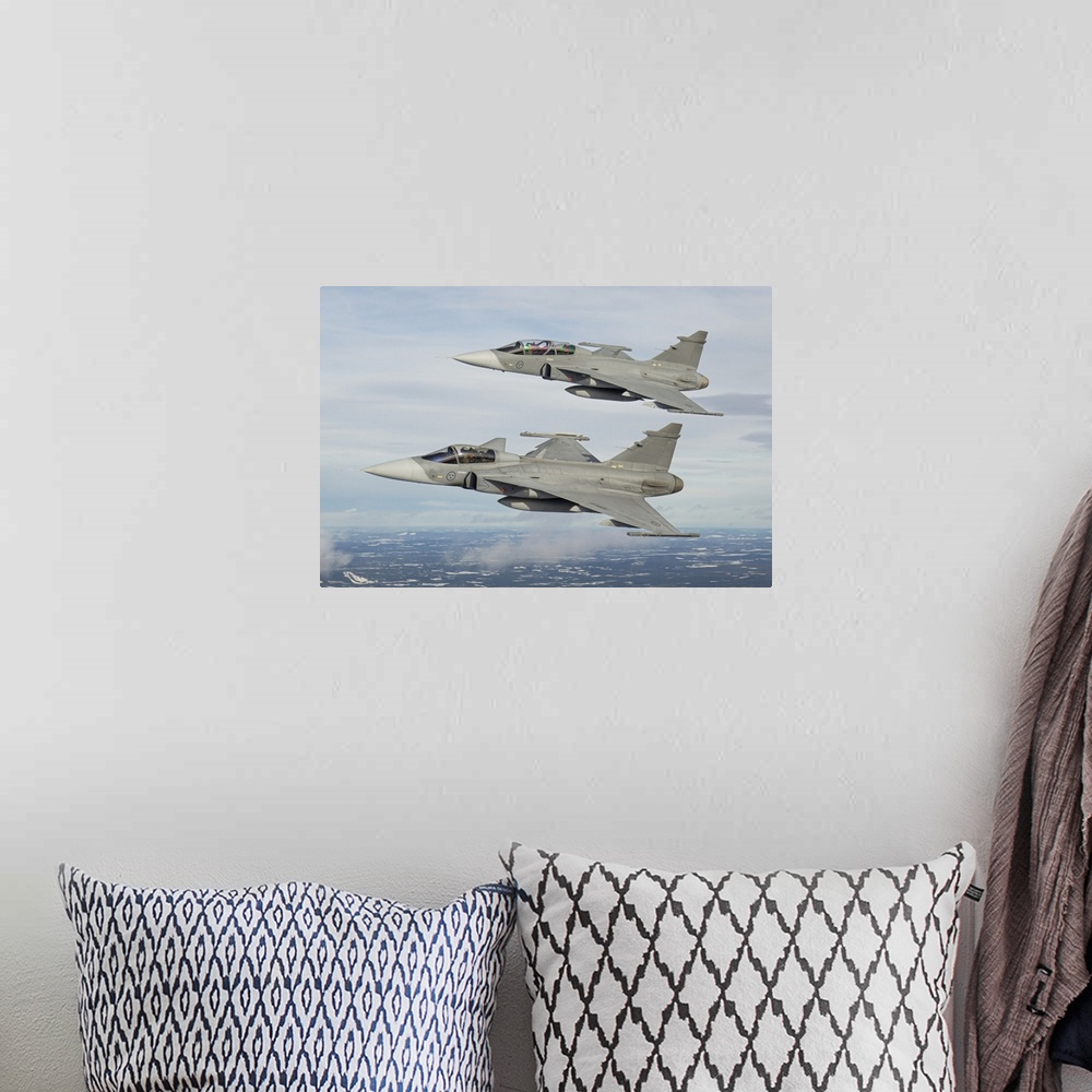A bohemian room featuring A pair of Swedish Air Force JAS-39 Gripen fighter jets in flight over northern Sweden.