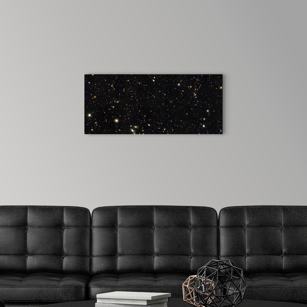 A modern room featuring Space photo of the night sky showing the thousands of galaxies in our universe. This small area o...