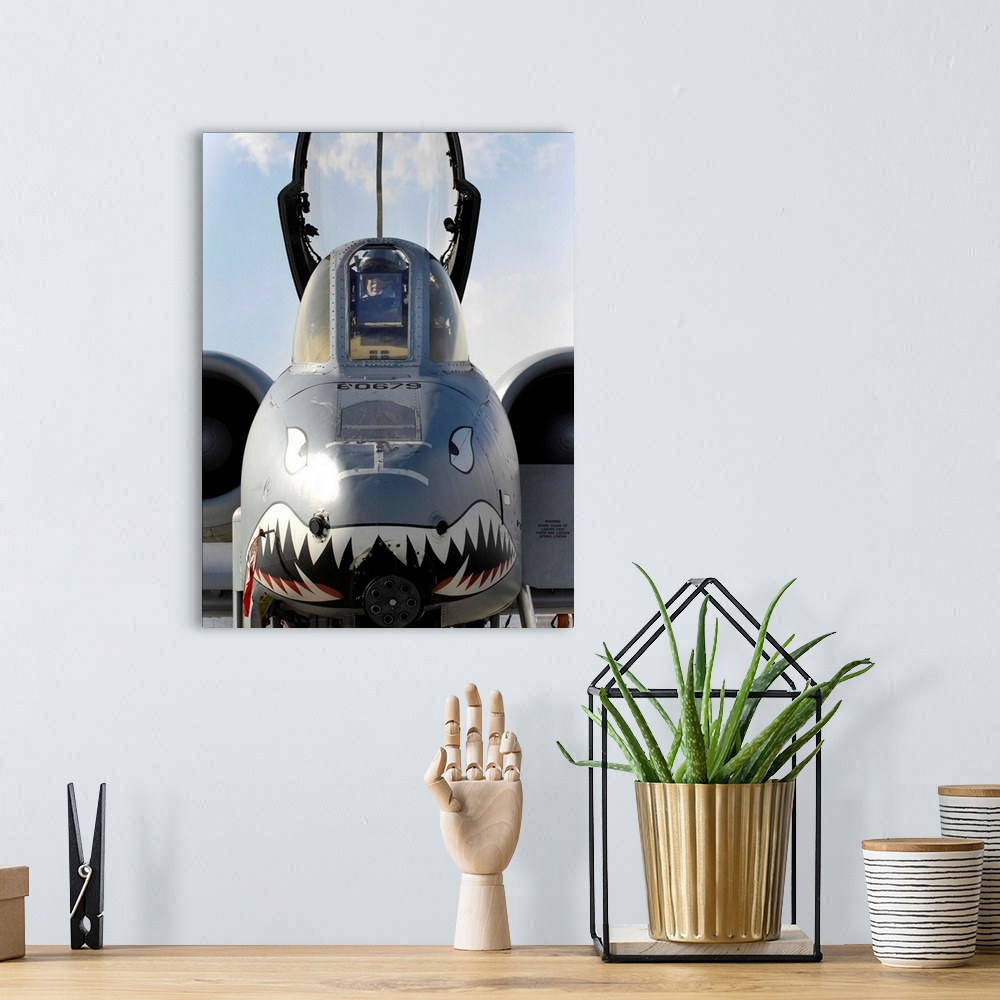 A bohemian room featuring A pilot prepares to dismount his A-10C Thunderbolt II.