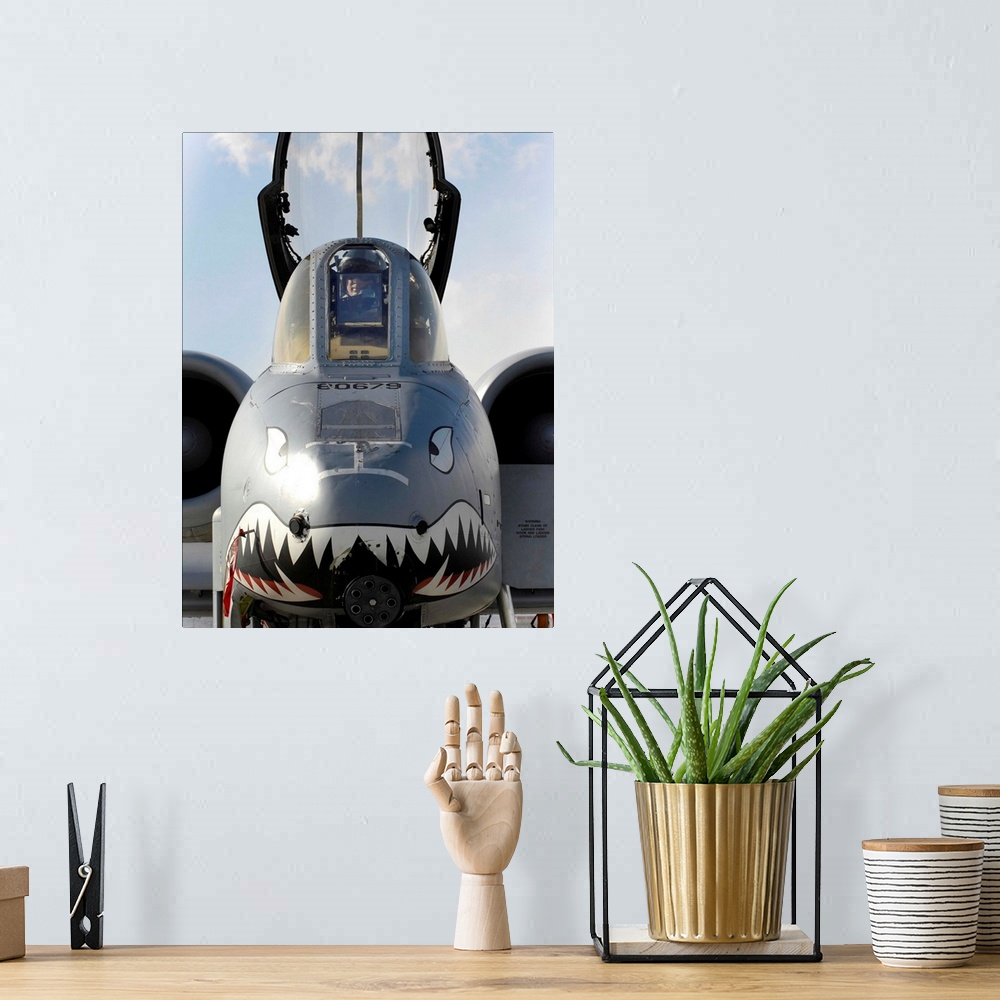 A bohemian room featuring A pilot prepares to dismount his A-10C Thunderbolt II.