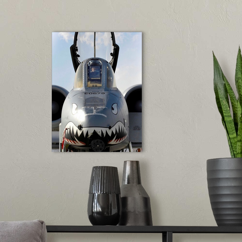 A modern room featuring A pilot prepares to dismount his A-10C Thunderbolt II.