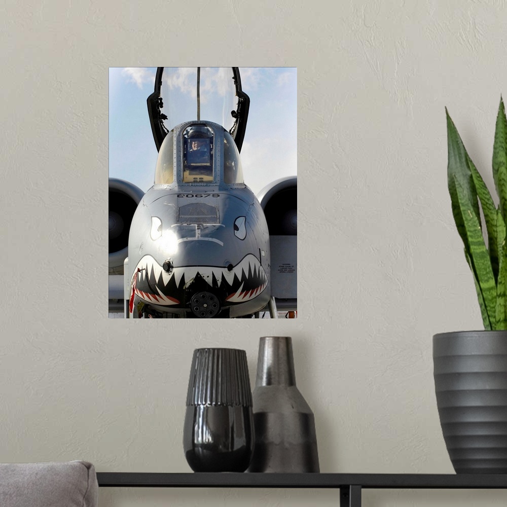 A modern room featuring A pilot prepares to dismount his A-10C Thunderbolt II.