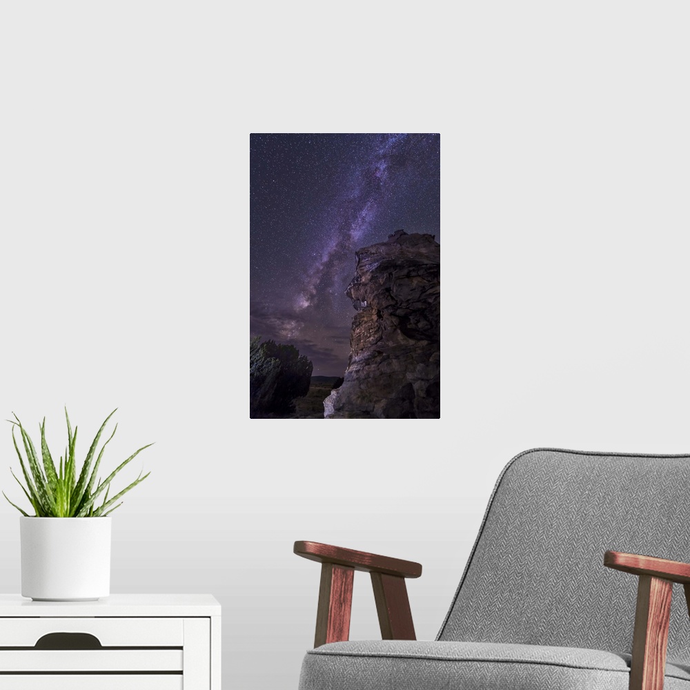 A modern room featuring A rocky hoodoo stands against the night sky as the Milky Way sets near Black Mesa, Oklahoma.