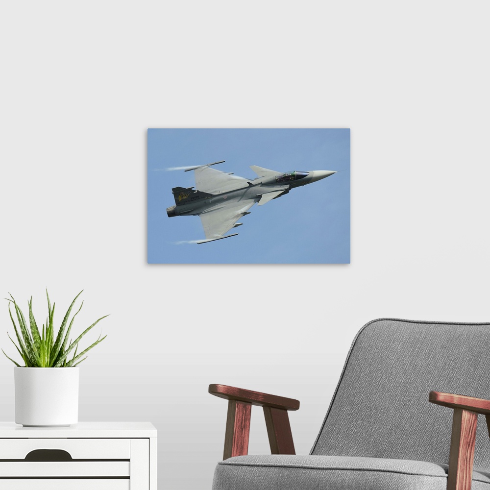 A modern room featuring A Saab JAS 39 Gripen C of the Royal Thai Air Force in flight.