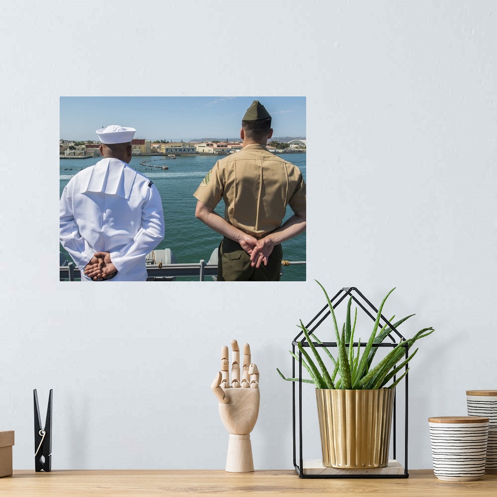 A bohemian room featuring San Diego, California, August 23, 2013 - A Sailor and Marine man the rails aboard the amphibious ...