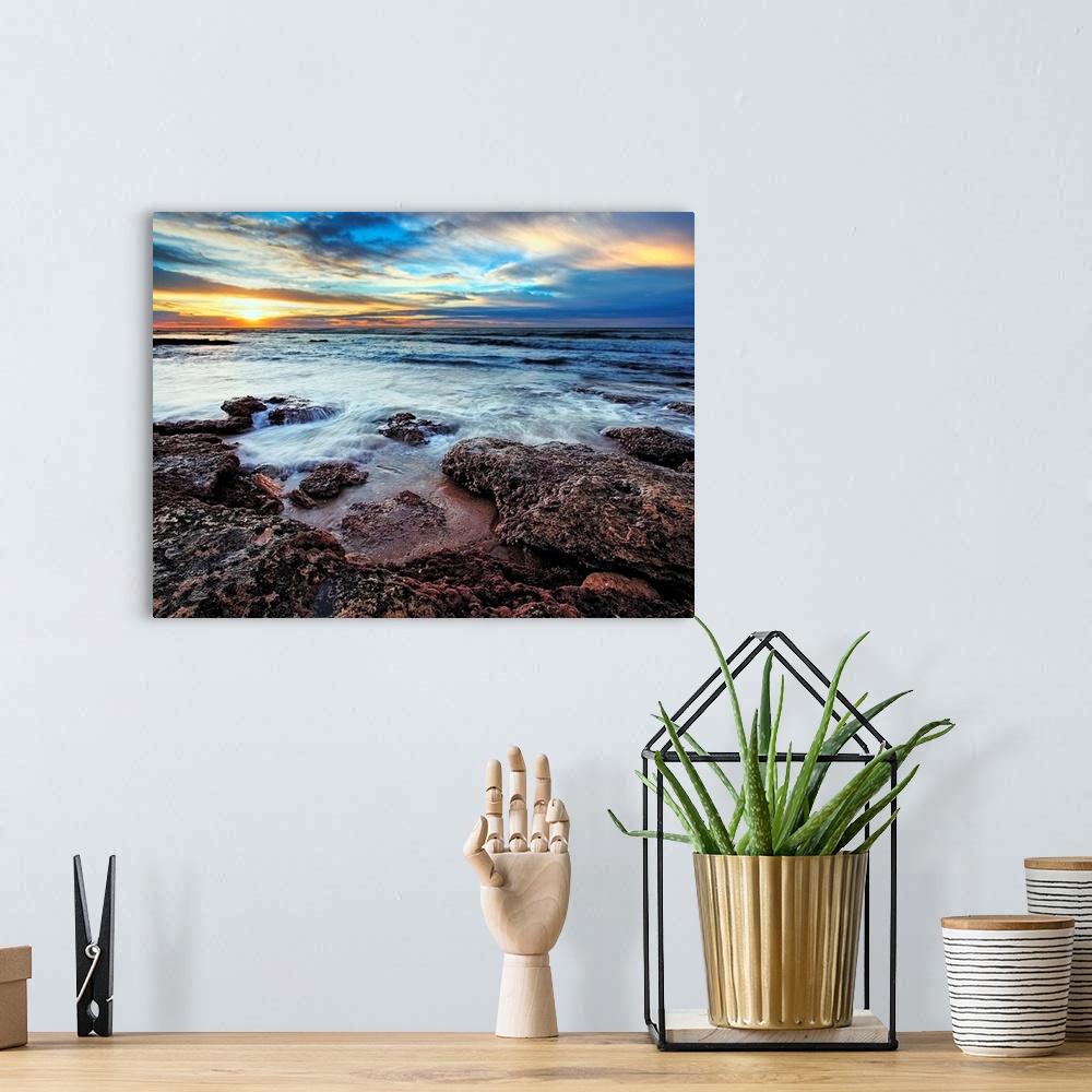 A bohemian room featuring Photograph taken of the ocean that rushes up onto rocks that are pictured in the foreground. The ...