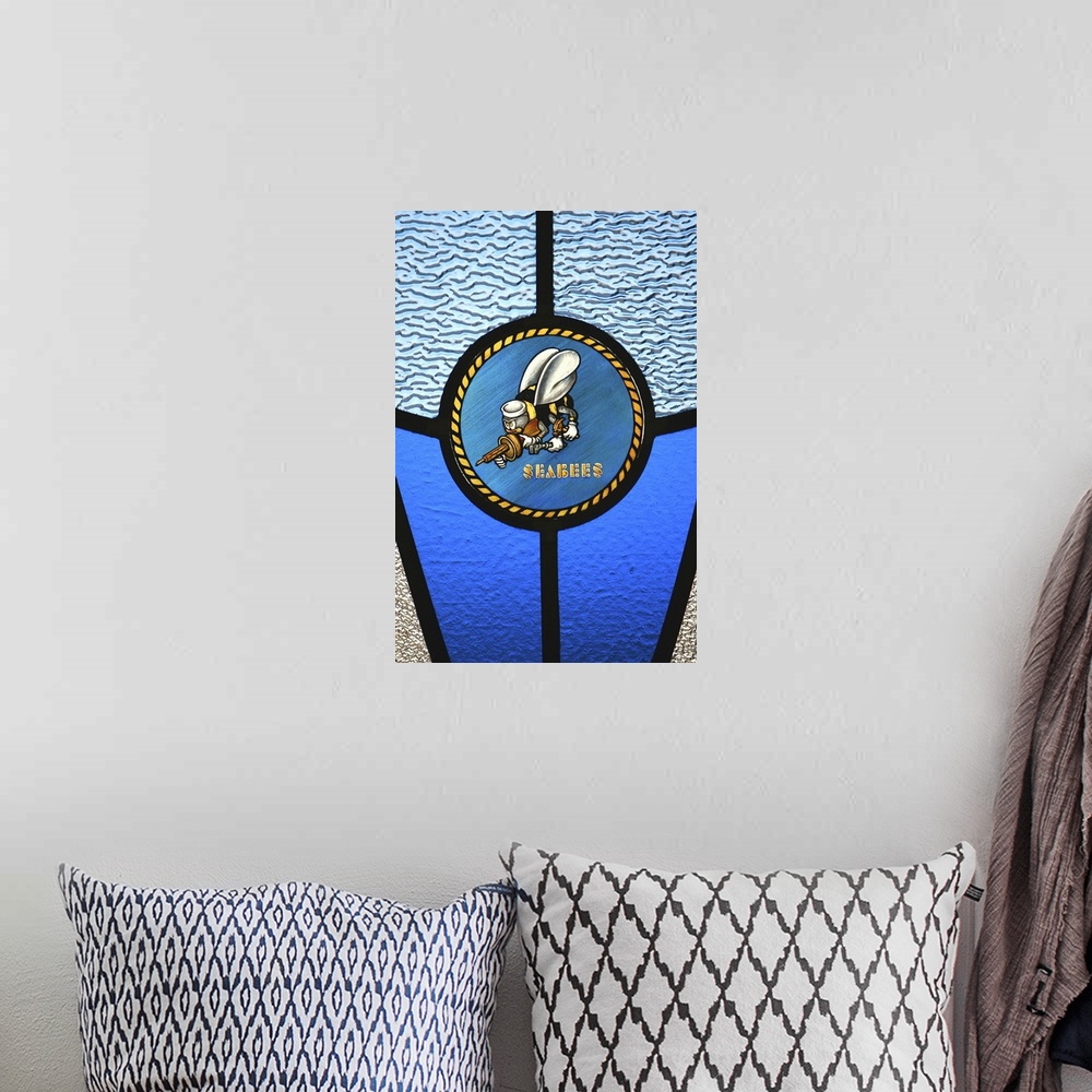 A bohemian room featuring A single Seabee logo built into a stainedglass window