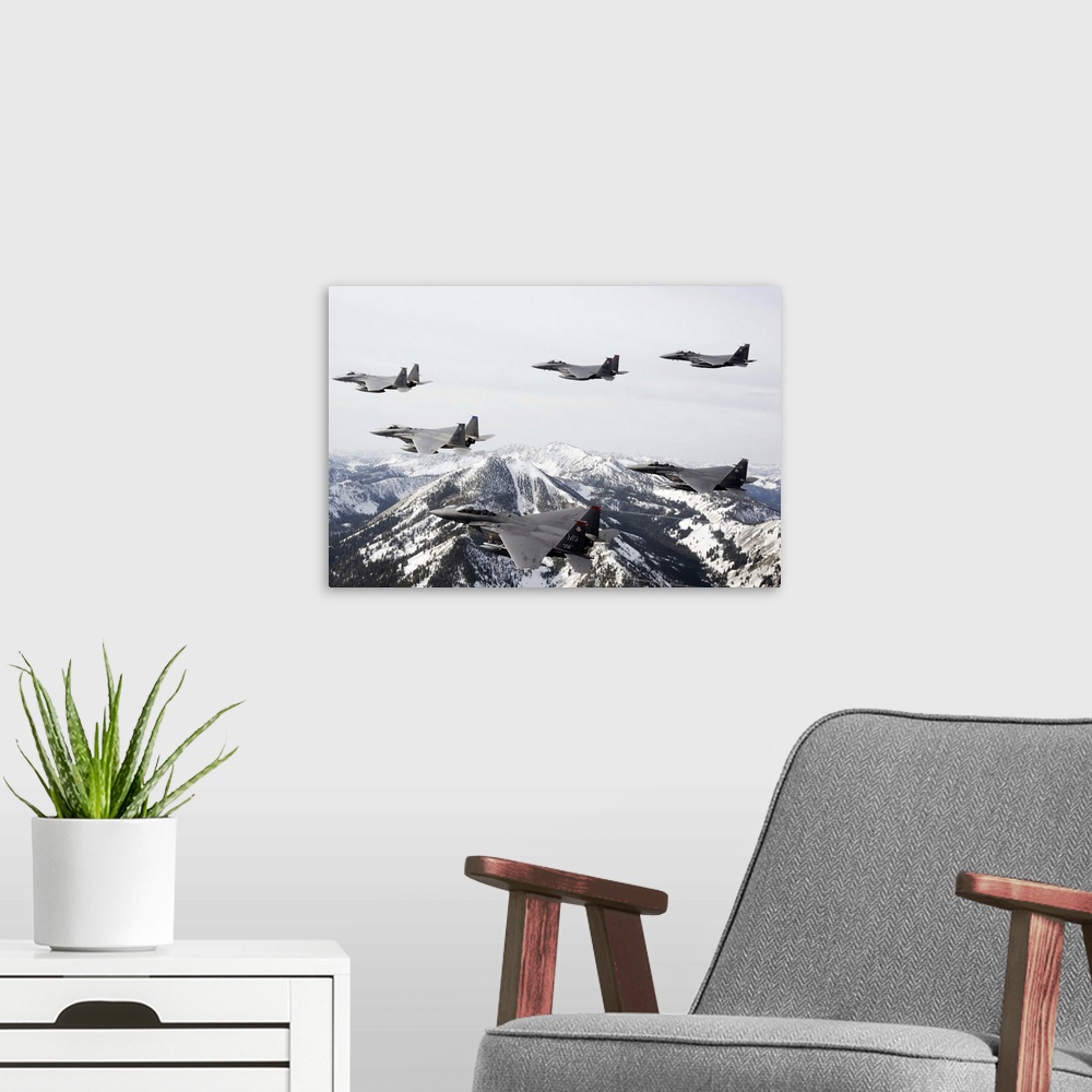 A modern room featuring Photograph of airplanes or jets flying over snow covered mountains.