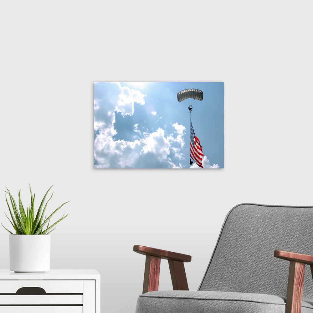 A modern room featuring A skydiver carries a U.S. flag while descending through the sky.