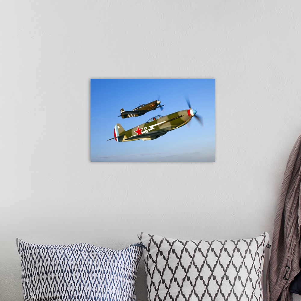 A bohemian room featuring A Soviet Yakovlev Yak-3 and a P-51A Mustang in flight over Chino, California.