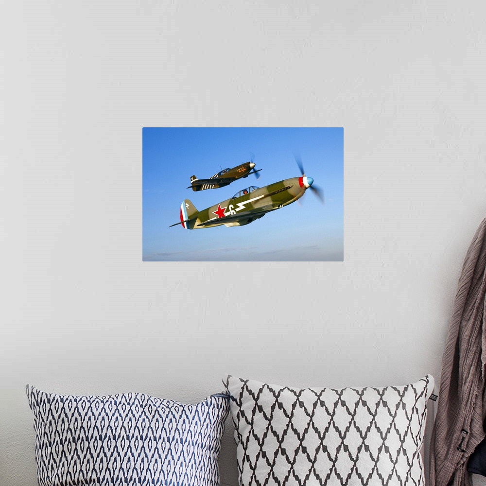 A bohemian room featuring A Soviet Yakovlev Yak-3 and a P-51A Mustang in flight over Chino, California.