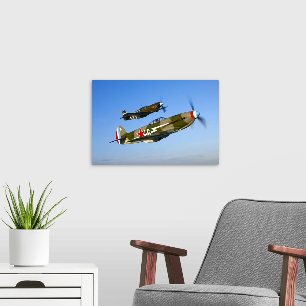 A modern room featuring A Soviet Yakovlev Yak-3 and a P-51A Mustang in flight over Chino, California.