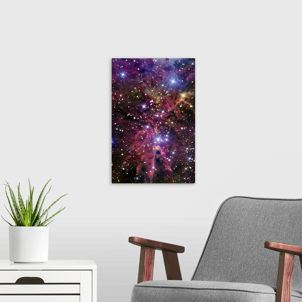 A modern room featuring This large piece consists of a cluster of bright stars with warm colored gases throughout.