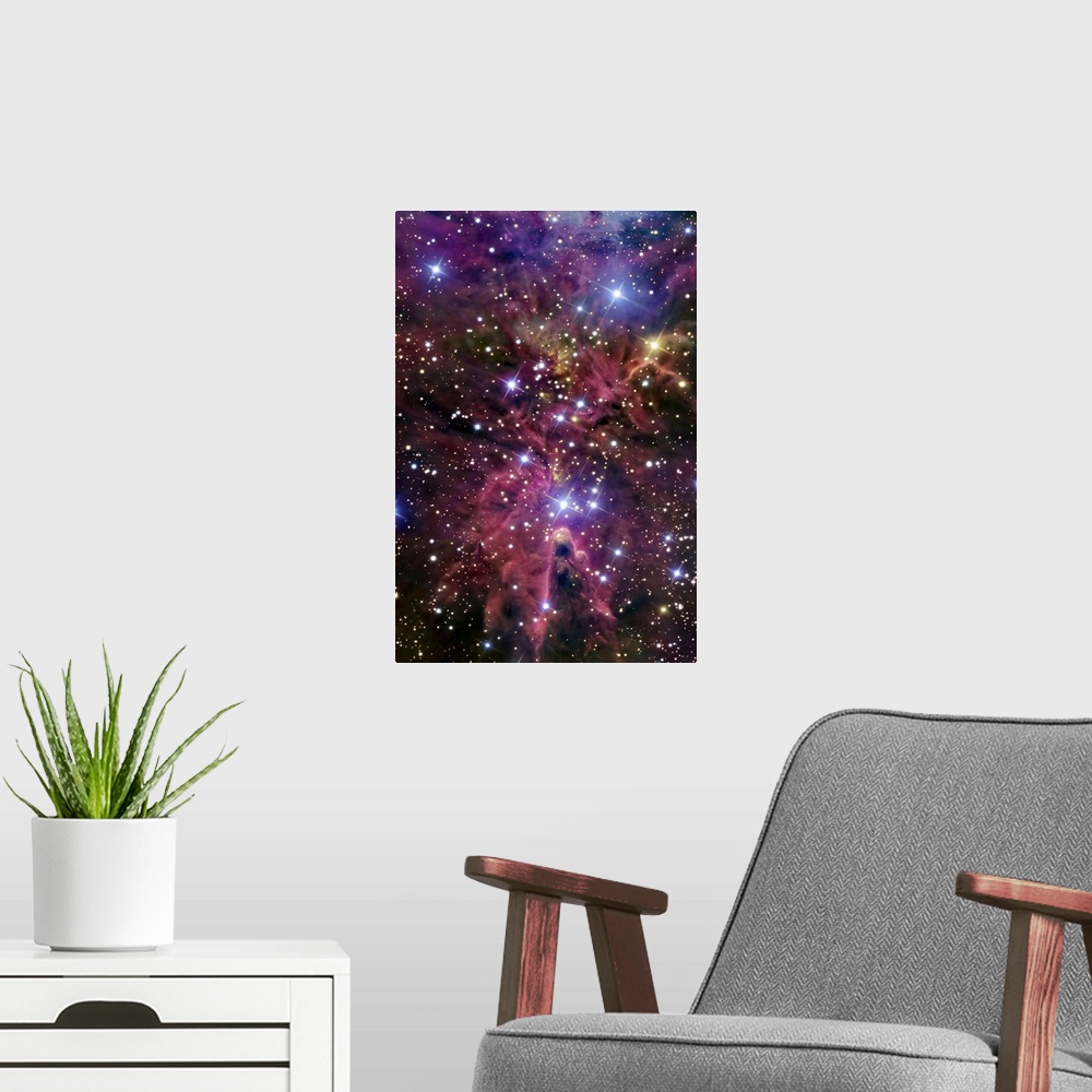 A modern room featuring This large piece consists of a cluster of bright stars with warm colored gases throughout.