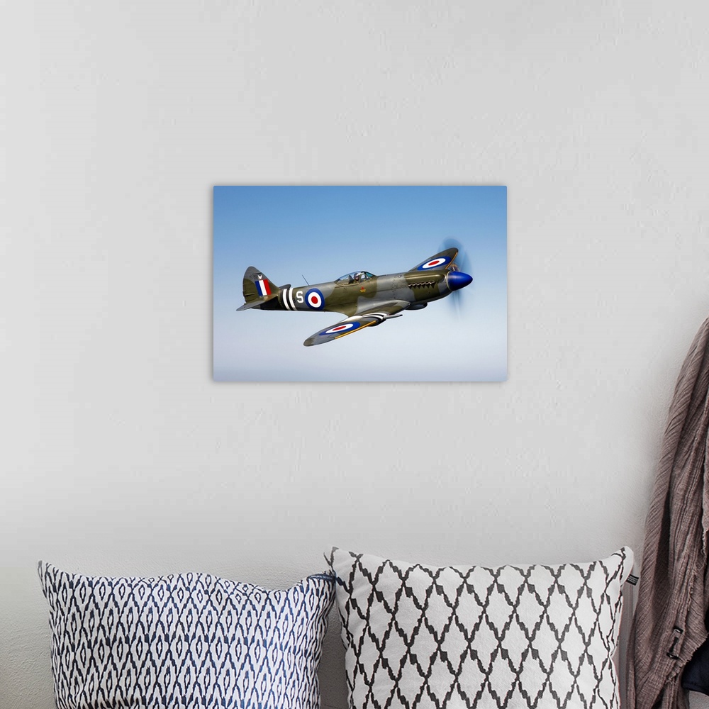 A bohemian room featuring An image of a vintage styled military jet flying through the sky printed on canvas.