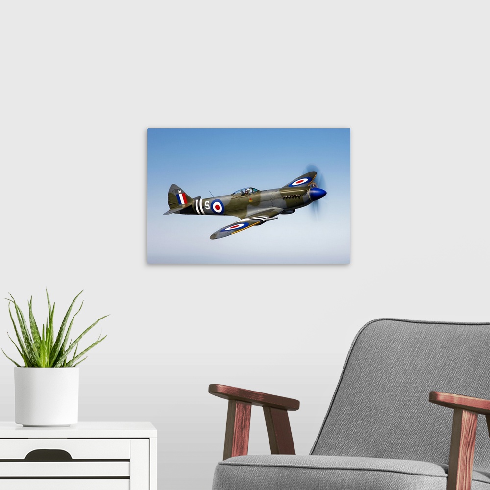 A modern room featuring An image of a vintage styled military jet flying through the sky printed on canvas.