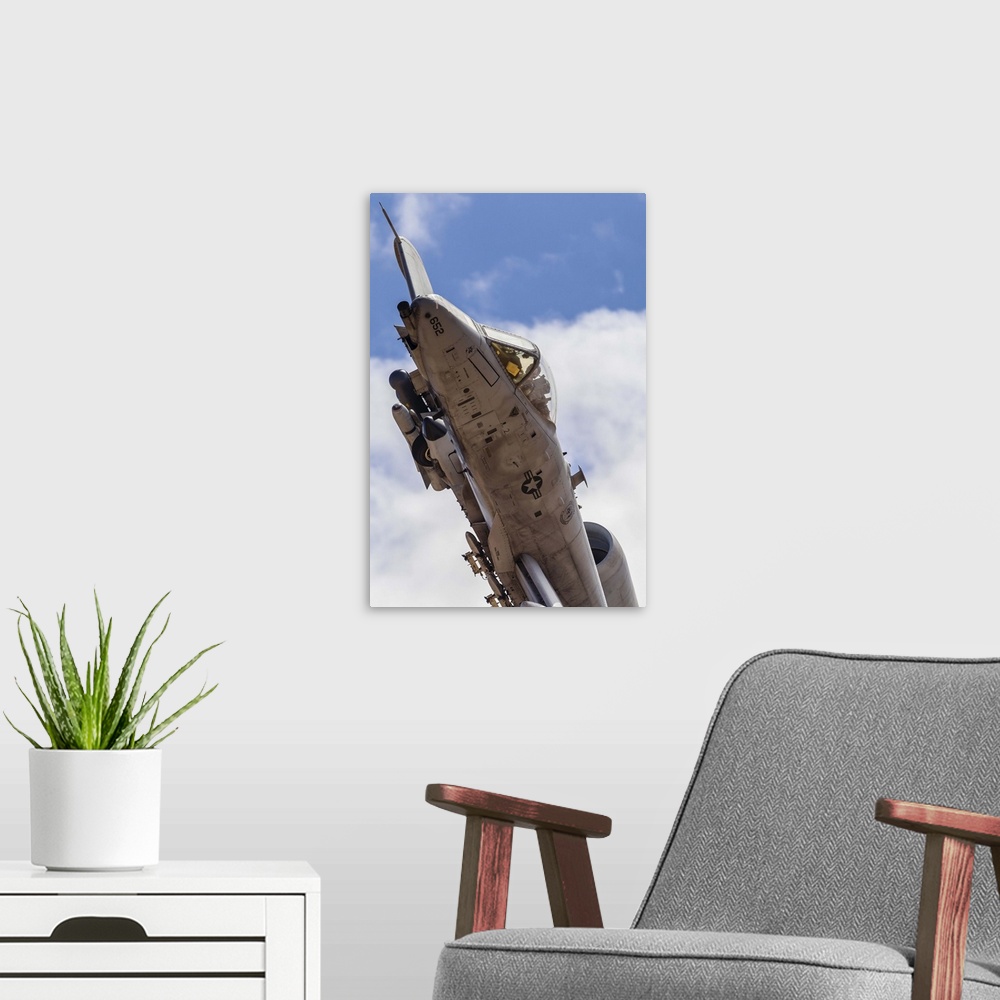 A modern room featuring A U.S. Air Force A-10 Thunderbolt II turns tight over the range tower after a weapons pass on the...