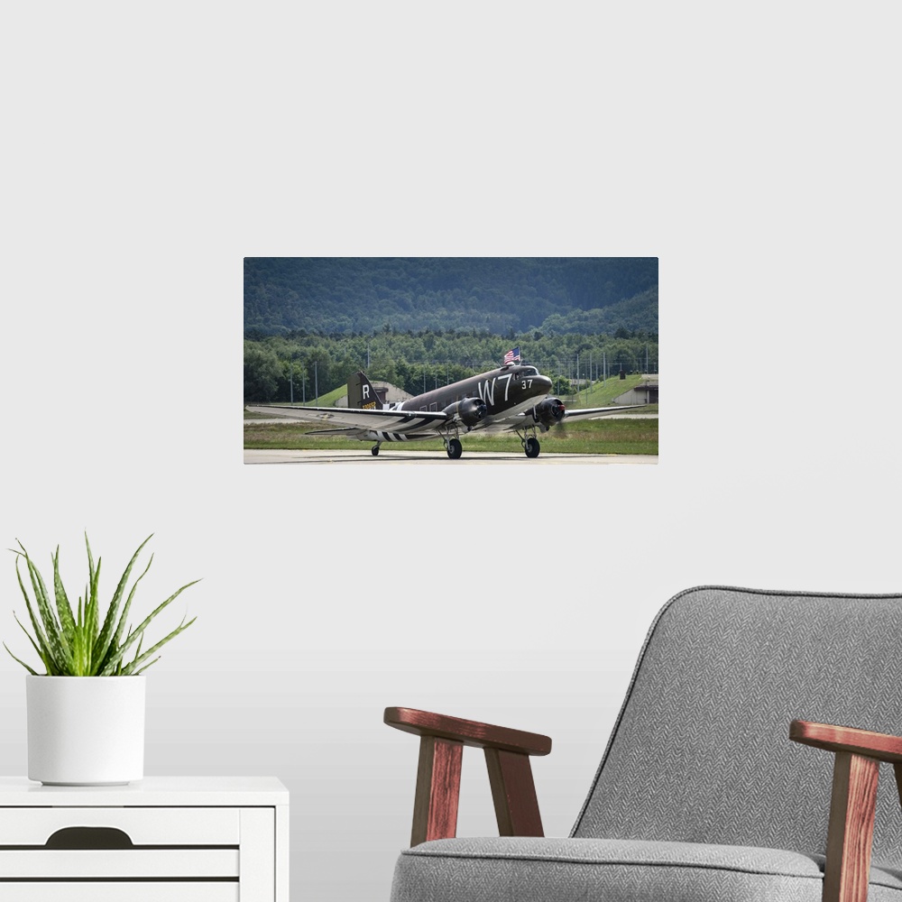A modern room featuring May 26, 2014 - A U.S. Air Force C-47 Skytrain aircraft lands at Ramstein Air Base, Germany, befor...