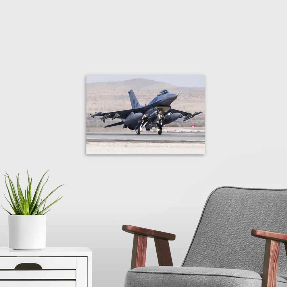 A modern room featuring A U.S. Air Force F-16C Fighting Falcon landing at Nellis Air Force Base, Nevada.