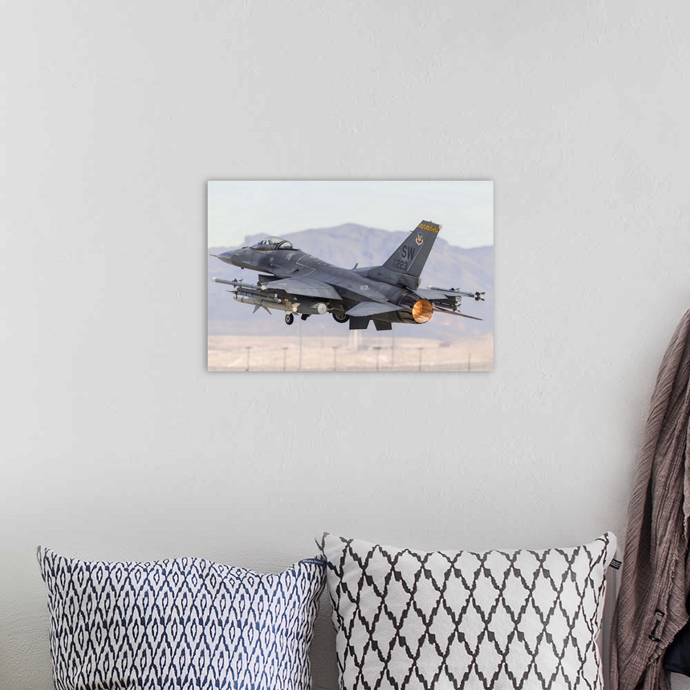 A bohemian room featuring A U.S. Air Force F-16C Fighting Falcon turns after taking off from Nellis Air Force Base, Nevada.