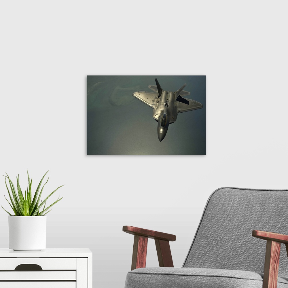 A modern room featuring April 25, 2014 - A U.S. Air Force F-22 Raptor flies after being in-air refueled over the U.S. Cen...