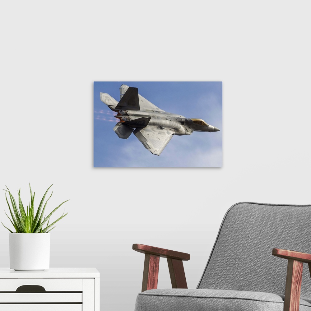 A modern room featuring A U.S. Air Force F-22 Raptor makes a fast flyby at Stead Field, Reno, Nevada.