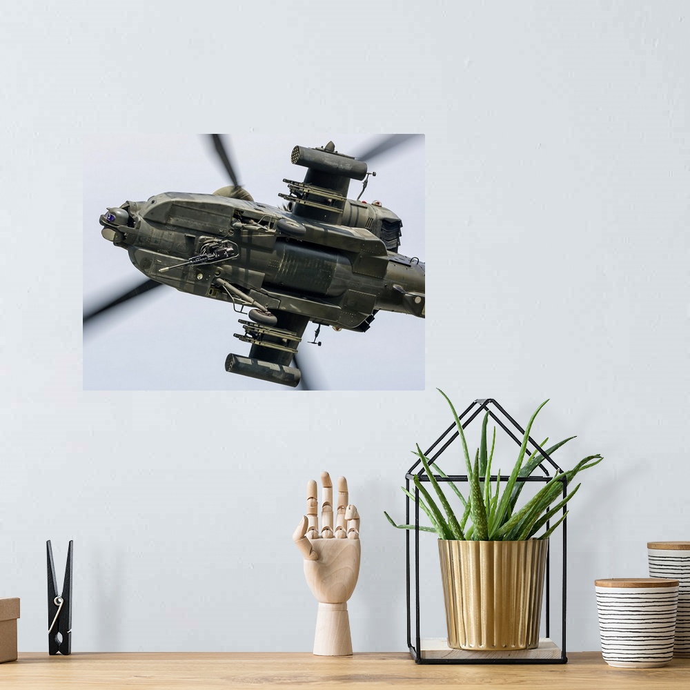A bohemian room featuring A U.S. Army AH-64D Apache Longbow pulls into a turn over Cleveland, Ohio.