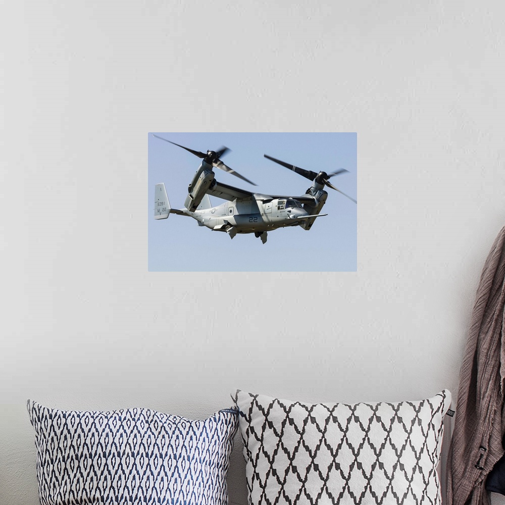 A bohemian room featuring A U.S. Marine Corps V-22 Osprey transitions to wingborne flight at RAF Fairford, England.