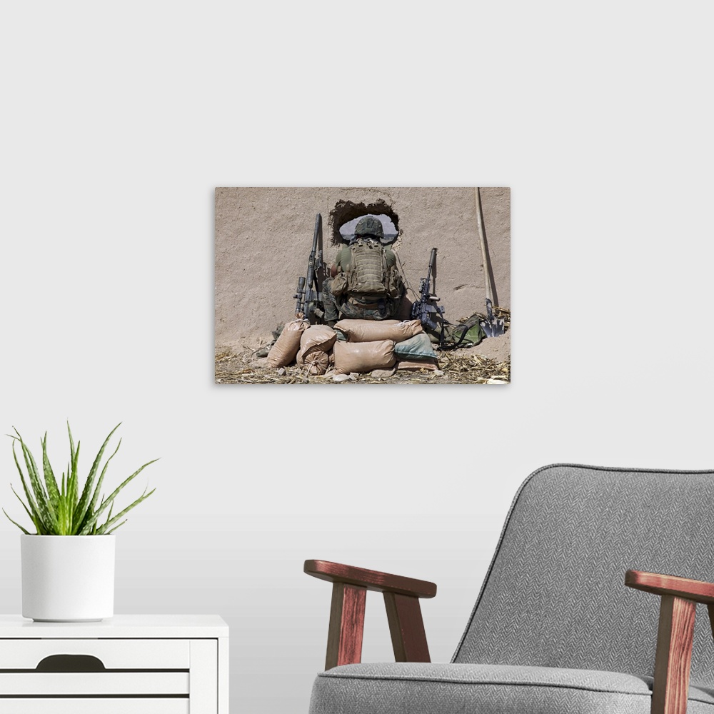 A modern room featuring October 14, 2010 - A U.S. Marine sniper observes his sector at a patrol base near Sangin, Afghani...