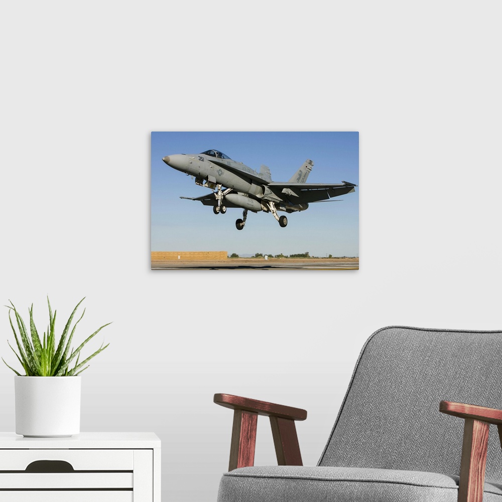A modern room featuring A U.S. Navy F/A-18C Hornet lands at Naval Air Facility El Centro, California.