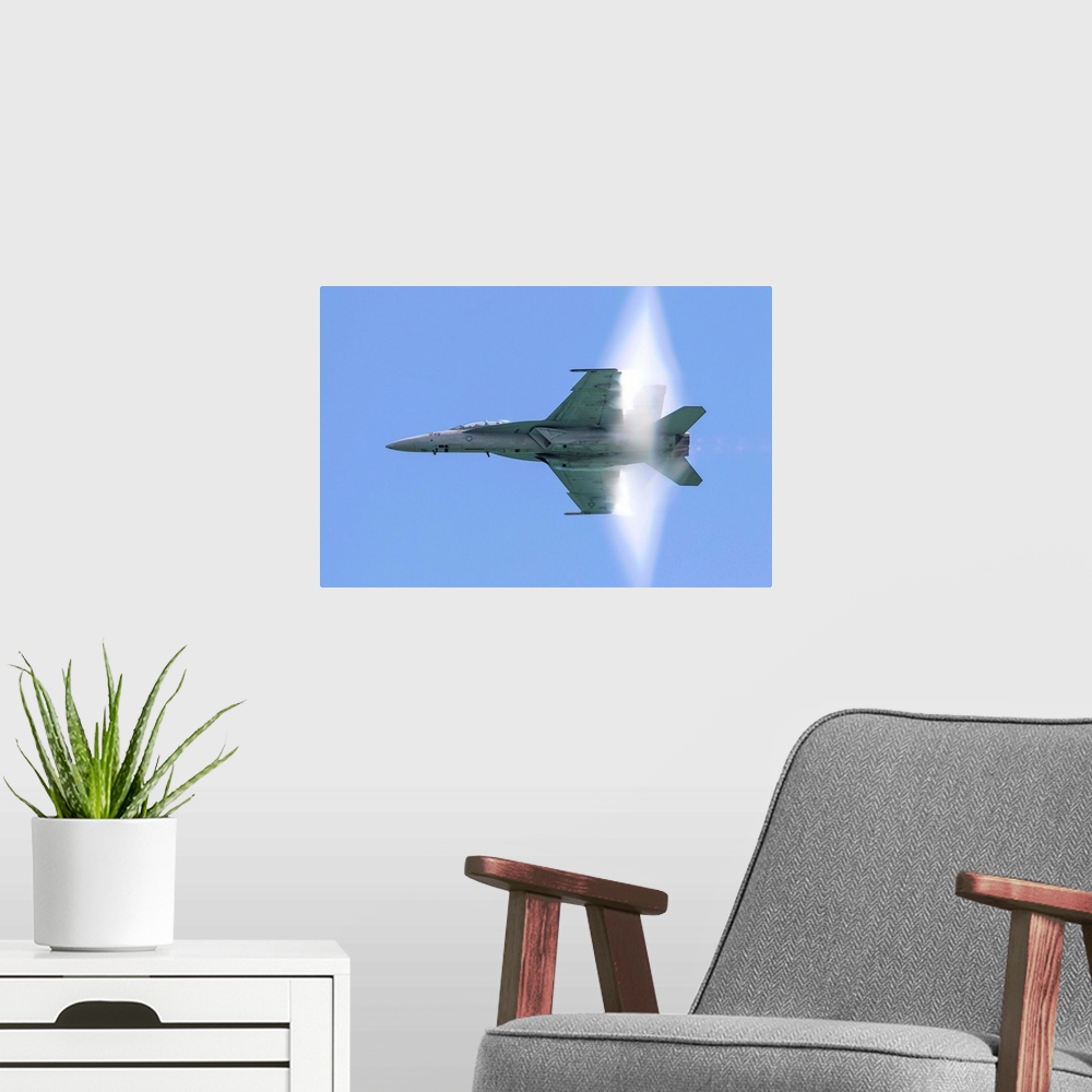 A modern room featuring A U.S. Navy F/A-18F Super Hornet flies by at high transonic speed.