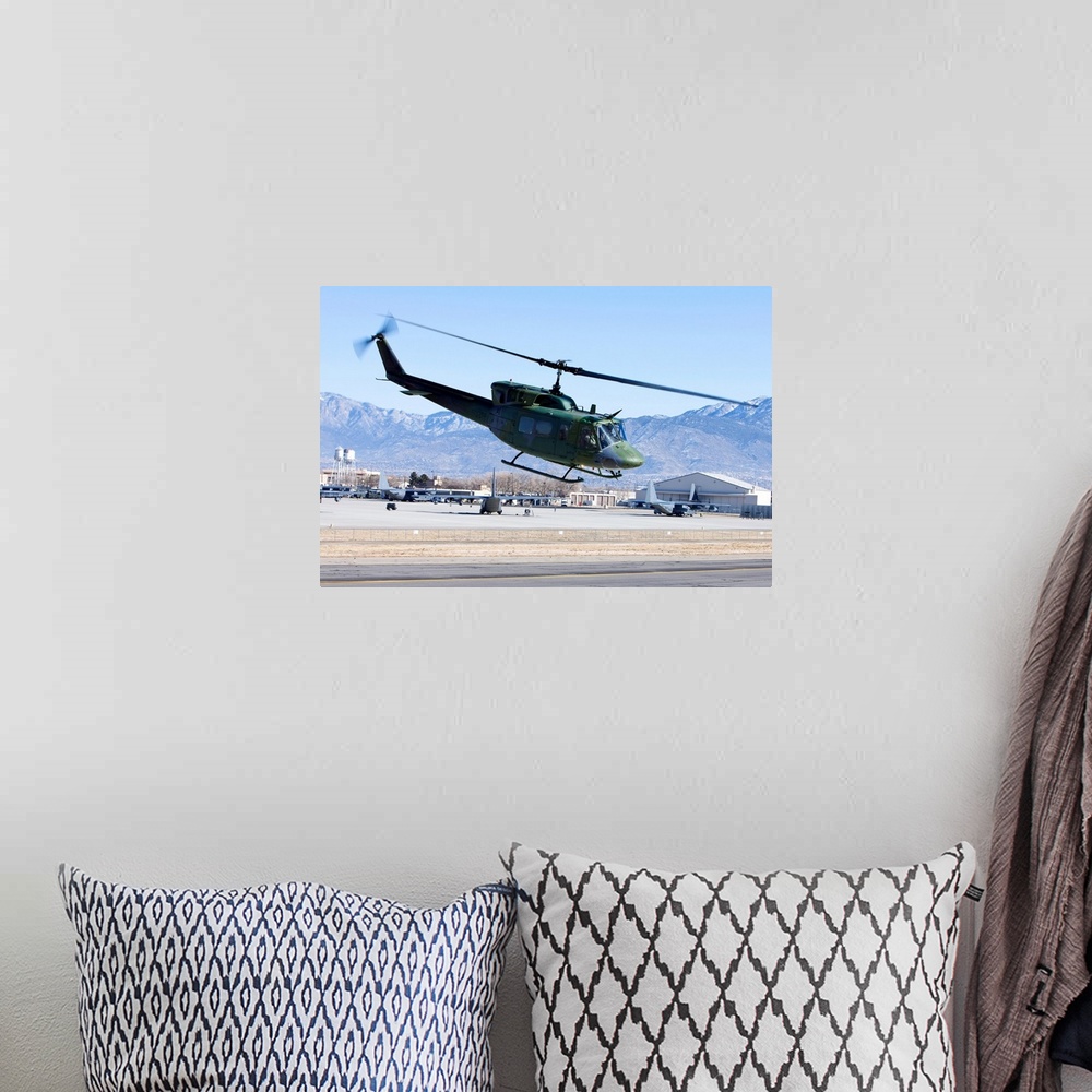 A bohemian room featuring A UH-1N Twin Huey from the 512th RQS flies a training mission near Kirtland Air Force Base, New M...