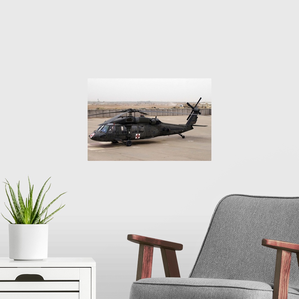 A modern room featuring A UH60 Blackhawk Medivac helicopter sits on the flight deck at Camp Warhorse
