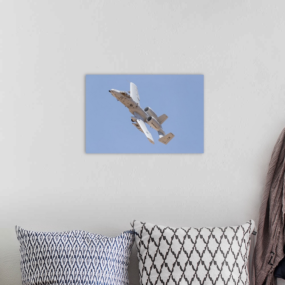 A bohemian room featuring A U.S. Air Force A-10 Thunderbolt II in flight.