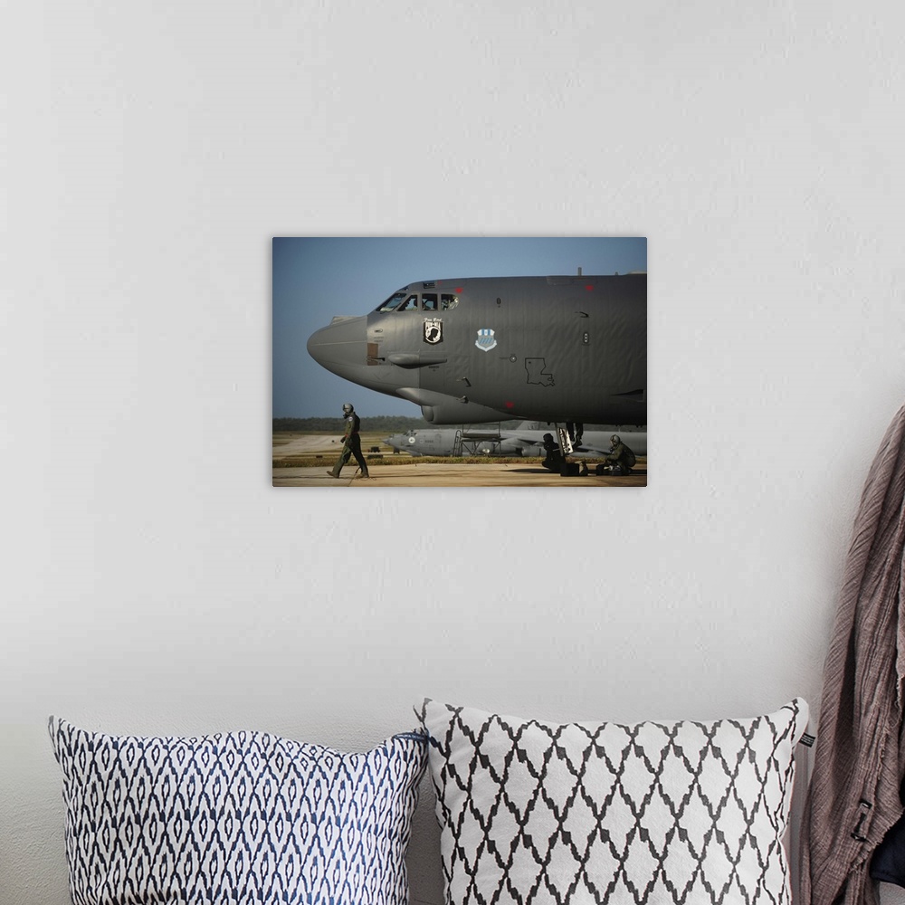 A bohemian room featuring A U.S. Air Force aircrew prepares a B-52 Stratofortress aircraft for a mission.