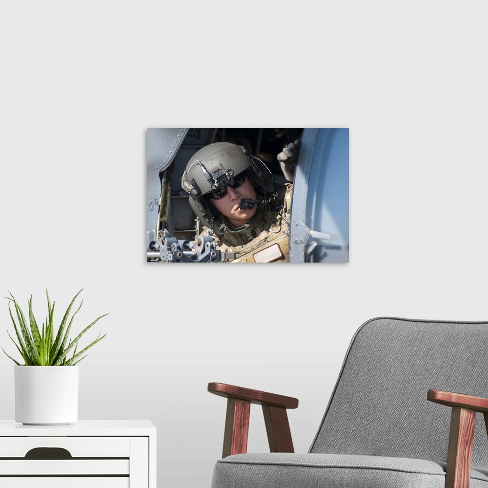 A modern room featuring San Diego, November 7, 2012 - A U.S. Air Force Airman peers out the side of a HH-60 Pave Hawk hel...
