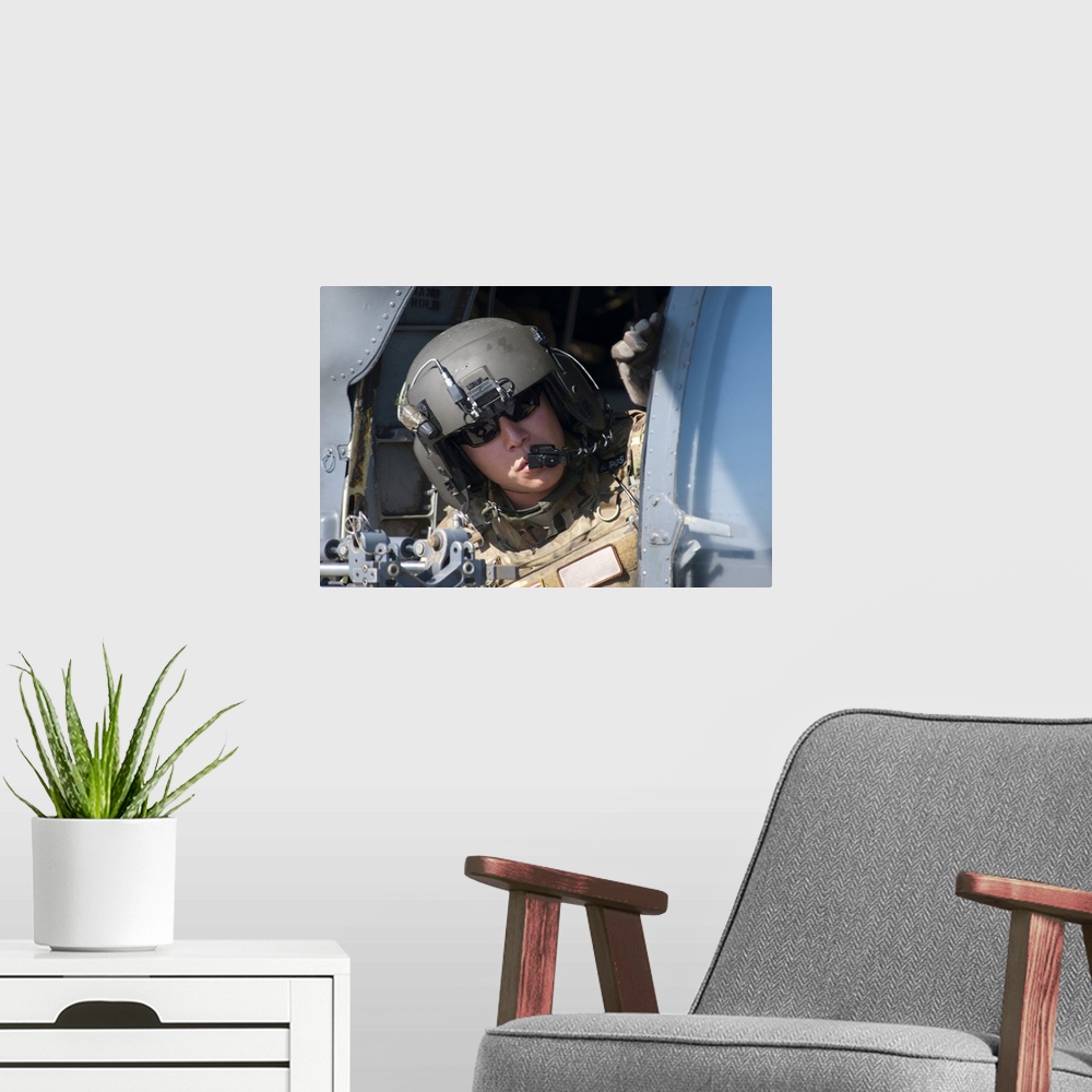 A modern room featuring San Diego, November 7, 2012 - A U.S. Air Force Airman peers out the side of a HH-60 Pave Hawk hel...