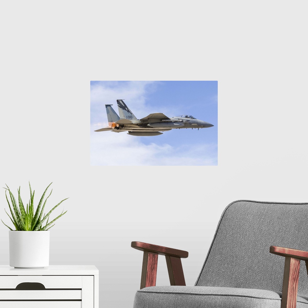 A modern room featuring A U.S. Air Force F-15C Eagle taking off from Nellis Air Force Base, Nevada.