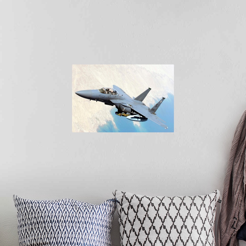 A bohemian room featuring A U.S. Air Force F-15E Strike Eagle aircraft flies over Iraq.
