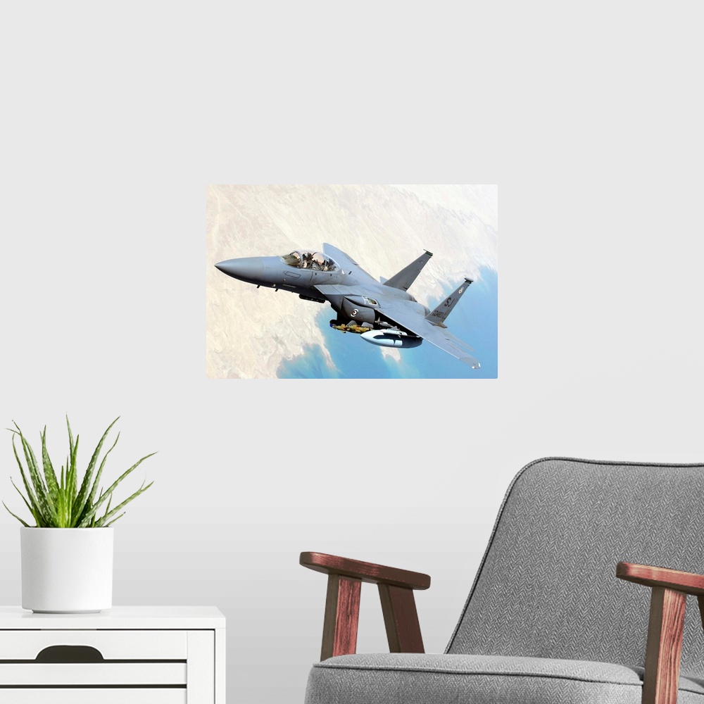A modern room featuring A U.S. Air Force F-15E Strike Eagle aircraft flies over Iraq.