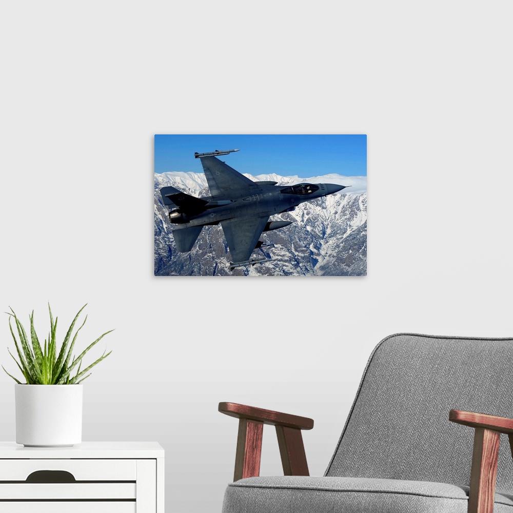 A modern room featuring A U.S. Air Force F-16 Fighting Falcon conducts operations over eastern Afghanistan.